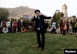 Afghanistan's Charlie Chaplin, Karim Asir, 25, performs in a school in Kabul Zoo, Afghanistan September 4, 2018. Picture taken September 4, 2018. REUTERS/Mohammad Ismail