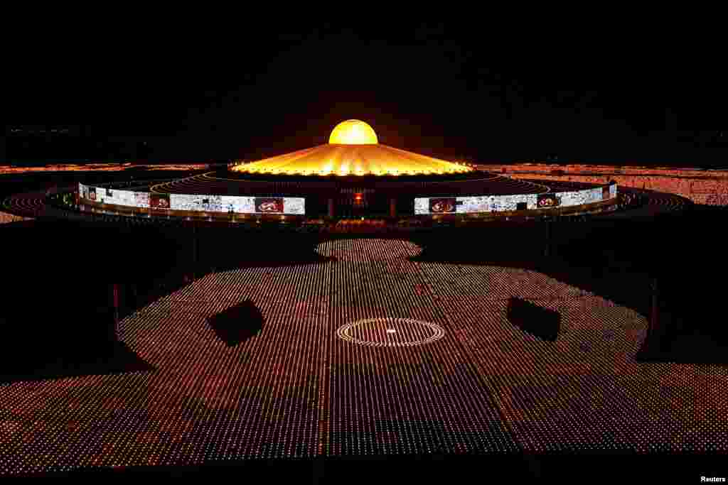 Buddhist monks of the Dhammakaya temple attend a meditation ceremony on Earth Day and light 330,000 candles arranged in the shape of the earth to set a Guinness World Record, in Pathum Thani province, Thailand.