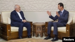 Syrian President Bashar al-Assad meets with Iran's Foreign Minister Mohammad Javad Zarif in Damascus, Syria, Sept. 3, 2018. 