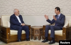 Syrian President Bashar al-Assad meets with Iran's Foreign Minister Mohammad Javad Zarif in Damascus, Syria, Sept. 3, 2018.