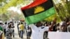 FILE - A supporter of Indigenous People of Biafra (IPOB) leader Nnamdi Kanu holds a Biafra flag during a rally in support of Kanu in Abuja, Nigeria, Dec. 1, 2015