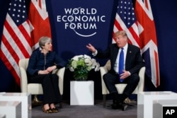 FILE - President Donald Trump meets with British Prime Minister Theresa May at the World Economic Forum in Davos, Jan. 25, 2018.