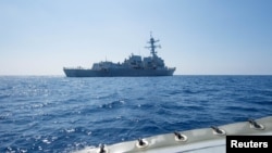 FILE - Arleigh Burke-class guided-missile destroyer USS Dewey transits the South China Sea.