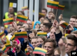 People wait for Pope Francis at Vilnius' airport, Lithuania, Sept. 22, 2018.