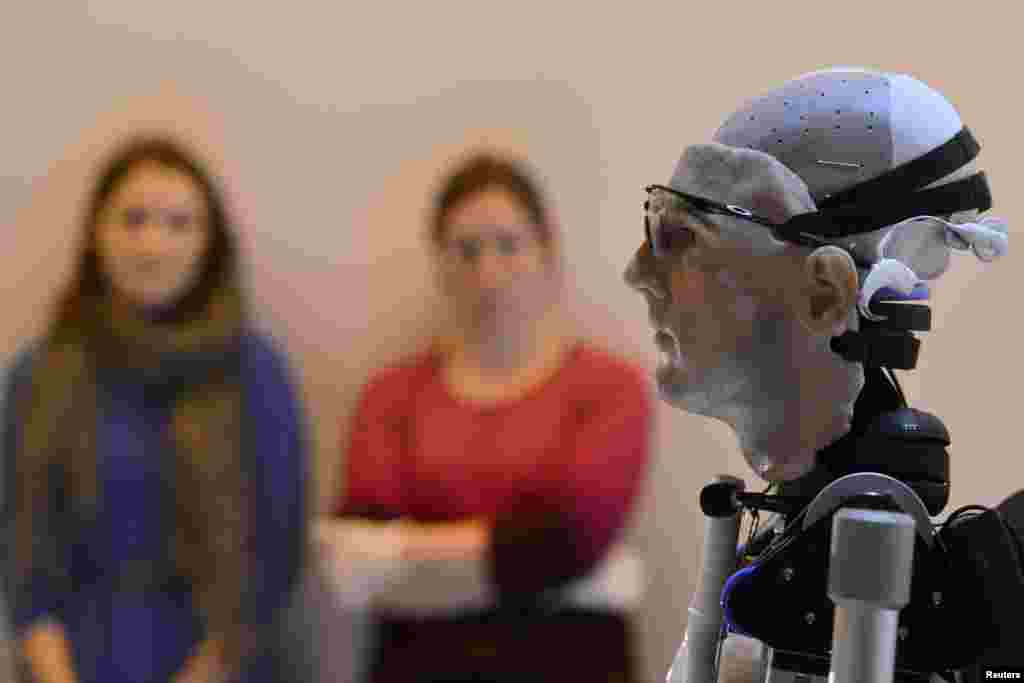 Workers look at &#39;Rex&#39;, a two-meter-tall artificial human, at the Science Museum in central London. British roboticist designers claim Rex is the world&#39;s first complete bionic man, featuring artificial organs as well as fully functioning limbs. 