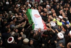 Warga Iran menandu peti jenazah Qaseem Soleimani jelang pemakamannya. (Foto: Reuters)