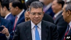 FILE - Malaysia's Foreign Minister Saifuddin Abdullah walks ahead of the Special Meeting of Foreign ministers of The Association of Southeast Asian Nations (ASEAN) coordination council in Vientiane, Laos, Feb. 20, 2020.