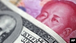 FILE - A Chinese 100 yuan banknote is placed under a $100 banknote (top) in this photo illustration.