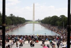 Participants surround the Reflecting Pool at the Lincoln Memorial as demonstrators gather for the "Get Your Knee Off Our Necks" March on Washington in support of racial justice in Washington, U.S., August 28, 2020. REUTERS/Jonathan Ernst/Pool