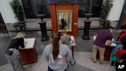 Visitors to the George H.W. Bush Presidential Library and Museum sign condolence books, Dec. 1, 2018, in College Station, Texas. 