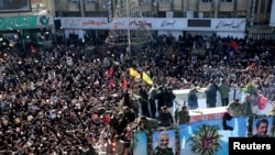 Iranian people attend a funeral procession and burial for Iranian Major-General Qassem Soleimani, head of the elite Quds Force, who was killed in an air strike at Baghdad airport, at his hometown in Kerman, Iran January 7, 2020.