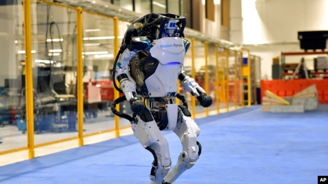 A Boston Dynamics Atlas robot performs a movement during a demonstration, Wednesday, Jan. 13, 2021, at the company's facilities in Waltham, Mass. (AP Photo/Josh Reynolds)