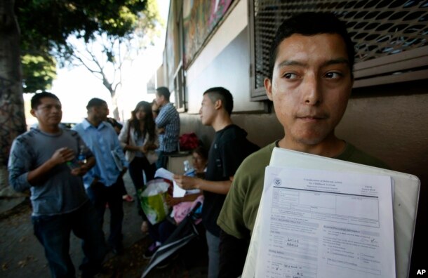 FILE - Illegal immigrant Layios Roberto waits outside the offices of Coalition for Humane Immigrant Rights in Los Angeles, Aug. 15, 2012.