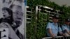 Police officers stand guards next to a portrait of jailed Chinese Nobel Peace laureate Liu Xiaobo during a demonstration outside the Chinese liaison office in Hong Kong, July 10, 2017.