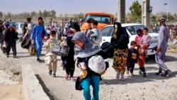 A handout picture made available by the Iranian Red Crescent on Aug. 19, 2021, shows Afghan refugees arriving at the Iran-Afghanistan border between Afghanistan and the southeastern Iranian Sistan and Baluchestan province.