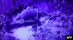 FILE - An image grab taken from a video released by the Iraqi Security Media Center on May 25, 2018, shows an airstrike by the Iraqi air force targeting a huge building in the Syrian area of Hajin, near the border with Iraq. Iraq was carrying out airstrikes against Islamic State fighters.