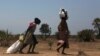 FILE - Women carry food at a food distribution site in Nyal, Unity State. More than one million people have been forced from their homes by the conflict, of which 803,200 have been displaced within South Sudan and 254,600 have fled to neighbouring countr