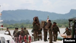 FILE - Myanmar soldiers arrive to Buthidaung jetty after Arakan Rohingya Salvation Army's (ARSA) attacks, at Buthidaung, Myanmar, Aug. 29, 2017. 