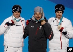 Men's combined medalists from left France's Alexis Pinturault, silver, Austria's Marcel Hirscher, gold, and France's Victor Muffat-Jeandet, bronze, pose during their medals ceremony at the 2018 Winter Olympics in Pyeongchang, South Korea, Feb. 11, 2018.
