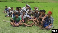 FILE - People gather near mass grave sites near Yebawkya village, Kamaungseik Township in Maungdaw District, Northern Rakhine State, Sept. 27, 2017. (Moe Zaw and Sithu Naing/VOA Burmese)