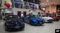 FILE - Toyota sedans are displayed in a showroom at Puente Hills Toyota in Industry, Calif., Feb. 14, 2019.