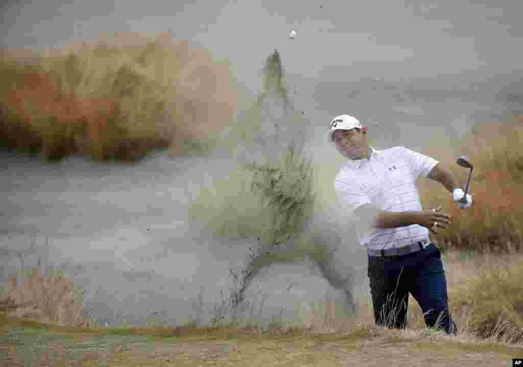 Gary Woodland hits out of the bunker on the 15th hole during the first round of the U.S. Open golf tournament at Chambers Bay in University Place, Washington.