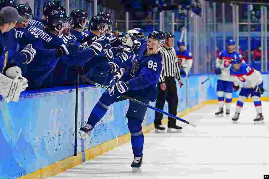 Finland&#39;s Harri Pesonen (82) celebrates after scoring a goal against Slovakia during a men&#39;s semifinal hockey game at the 2022 Winter Olympics, in Beijing. Finland won 2-0. 
