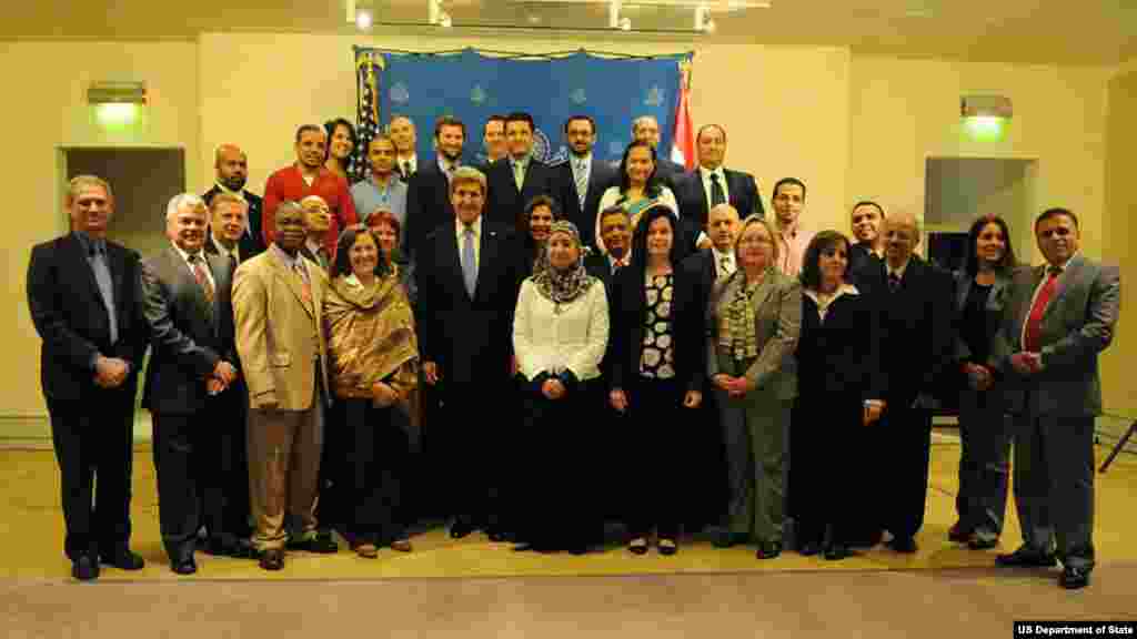 U.S. Secretary of State John Kerry poses for a photograph with staff members of the U.S. Embassy in Cairo, Egypt, on November 3, 2013.