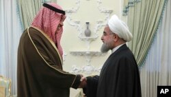 Iranian President Hassan Rouhani, right, welcomes Kuwait's Foreign Minister Sabah Khaled al-Sabah to their meeting, in Tehran, Iran, Jan. 25, 2017. 