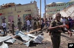 Somali soldiers guard the scene after a car bomb attack in Mogadishu, Somalia, March 13, 2017.