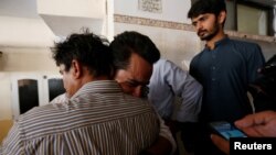 Relatives mourn the death of Khurram Zaki, who was shot by gunmen, during his funeral in Karachi, Pakistan, May 8, 2016. 