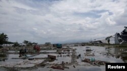 The ruins of cars are seen after a tsunami hit in Palu, Indonesia, Sept. 29, 2018.