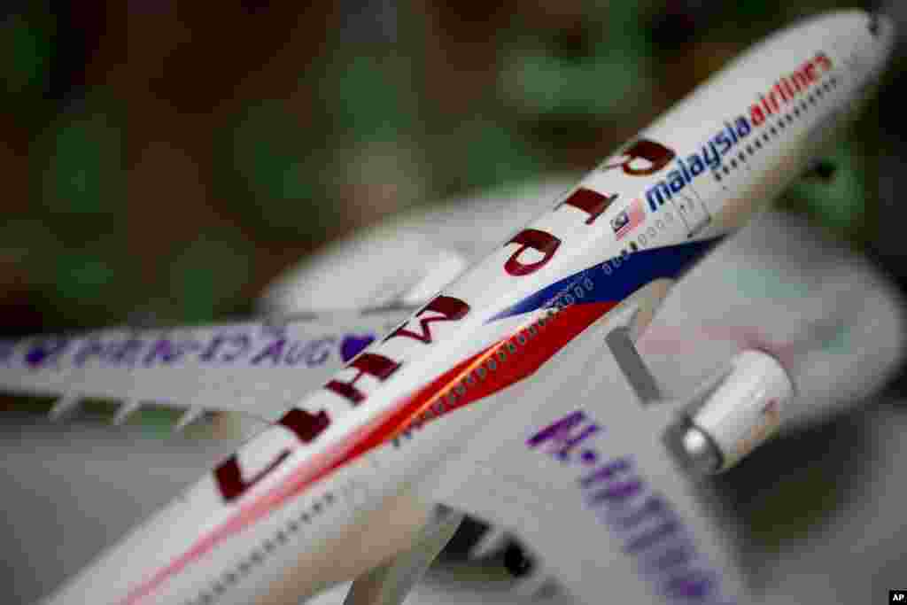 A Malaysia Airlines miniature plane with a text reading "RIP MH17" is displayed at a memorial site for the victims of the MH17 air disaster at Schiphol Airport in Amsterdam, Netherlands, Sept. 9, 2014.