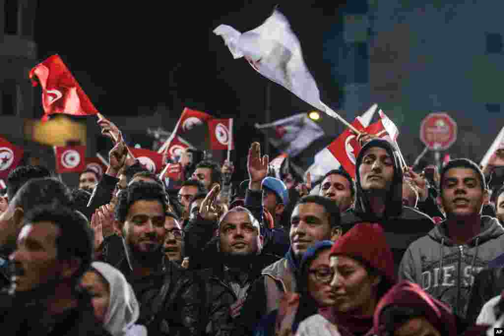 Supporters gather as Tunisian presidential candidate Moncef Marzouki gives a speech, after the second round of the country's presidential election, in Tunis, Sunday, Dec. 21, 2014.