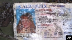 A California driver's license bearing the name of Jenni Rivera sits on the ground at the site where a plane allegedly carrying Rivera crashed near Iturbide, Mexico, December 9, 2012.