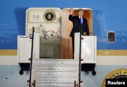 U.S. President Donald Trump waves upon his arrival at Paya Lebar Air Base in Singapore, before his summit with North Korean leader Kim Jong Un, June 10, 2018.