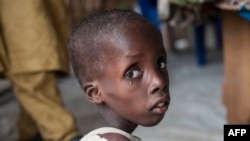 FILE - A boy suffering from severe acute malnutrition sits at one of the UNICEF nutrition clinics, in the Muna informal settlement, which houses nearly 16,000 IDPs (internally displaced people) in the outskirts of Maiduguri capital of Borno State, northeastern Nigeria.