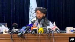 aliban spokesman Zabihullah Mujahid speaks at at his first news conference in Kabul, Afghanistan, Tuesday, Aug. 17, 2021. For years, Mujahid had been a shadowy figure issuing statements on behalf of the militants. 