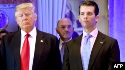 US President-elect Donald Trump along with his son Donald, Jr., arrive for a press conference at Trump Tower in New York, as Allen Weisselberg, chief financial officer of The Trump, looks on.