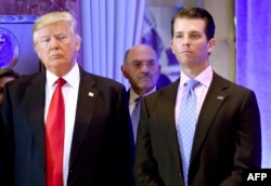 US President-elect Donald Trump along with his son Donald, Jr., arrive for a press conference at Trump Tower in New York, as Allen Weisselberg, chief financial officer of The Trump, looks on.