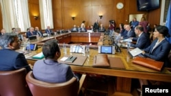 FILE - Iran's Deputy Foreign Minister Hossein Jaberi Ansari, Russian envoy Alexander Lavrentiev, Turkish Deputy Foreign Minister Sedat Onal and U.N. envoy Staffan de Mistura attend a meeting on Syria at European U.N. headquarters in Geneva, Sept. 11, 2018.