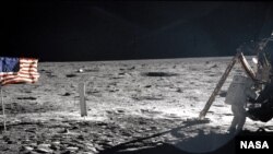 Neil Armstrong getting equipment form the Lunar Module "Eagle" on the surface of the moon. The picture was taken by Buzz Aldrin.