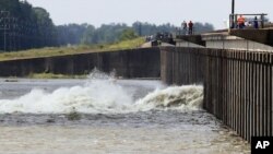 Water diverted from the Mississippi River spills through a bay in the Morganza Spillway in Morganza, La., Saturday, May 14, 2011.