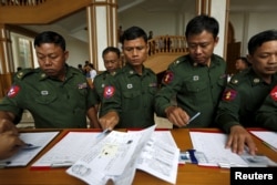 Myanmar's army members of the parliament arrive at the Union Parliament session in Naypyitaw, Jan. 28, 2016.