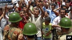 Anti-government protesters shout at soldiers at an army barrier blocking a demonstration demanding the ouster of Yemen's President Ali Abdullah Saleh in the southern city of Taiz, May 3, 2011