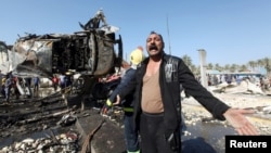 A man reacts at the site of a bomb attack at a checkpoint in the city of Hilla, south of Baghdad, Iraq, March 6, 2016. 