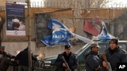 Afghan police stand guard at a site of a blast in the center of Kabul, 28 Nov 2009