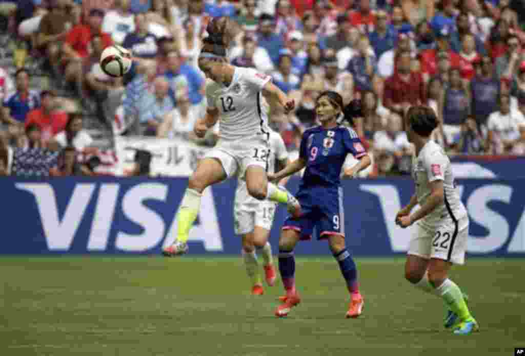 United States' Lauren Holiday (12) heads the ball above Japan's Nahomi Kawasumi (9) during the first half of the FIFA Women's World Cup soccer championship in Vancouver, British Columbia, Canada, Sunday, July 5, 2015. (AP Photo/Elaine Thompson)