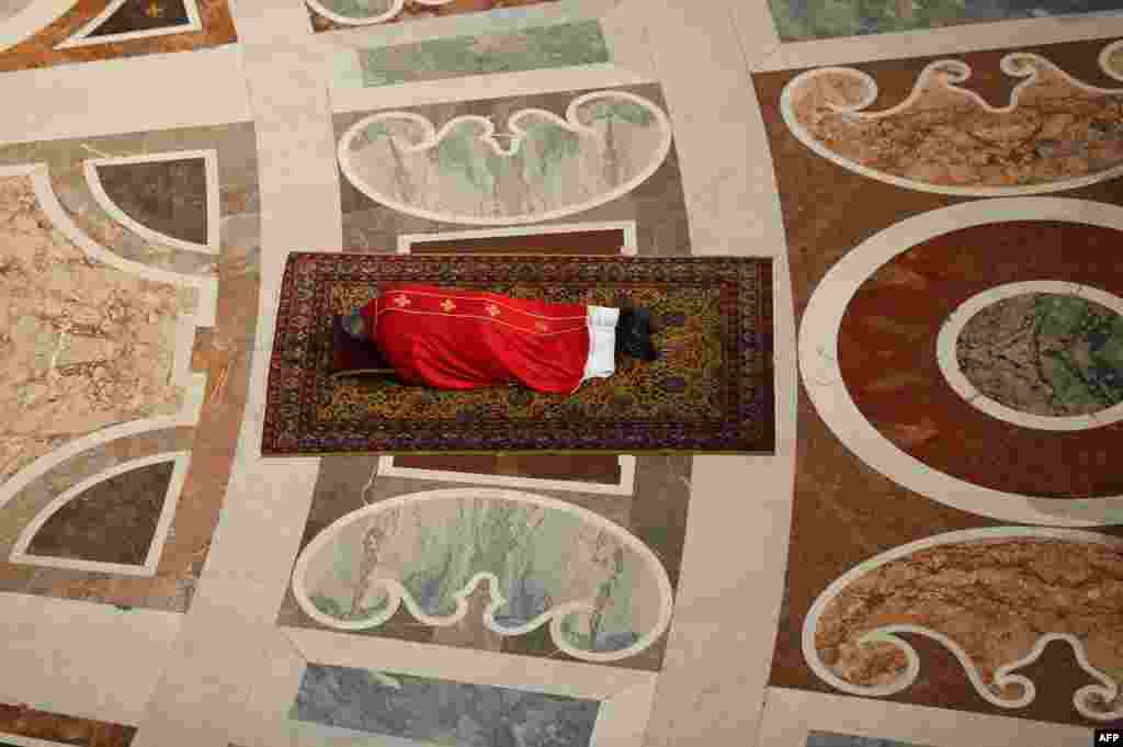 Pope Francis lies on the floor as he prays during the Celebration of the Lord&rsquo;s Passion on Good Friday at St Peter&#39;s Basilica at the Vatican.