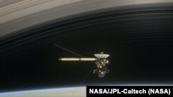 Artist's concept of Cassini diving between Saturn and its innermost ring (Credit: NASA/JPL-Caltech)